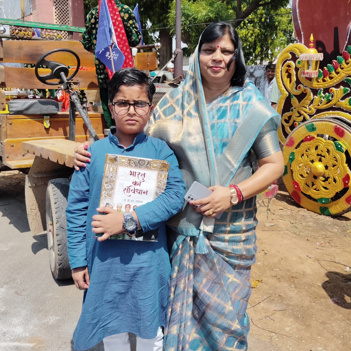 Family member holding the Constitution of India